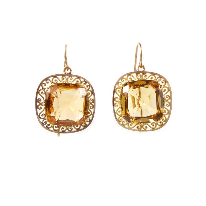 Pair of yellow topaz and gold earrings, each set with a cushion shaped mixed cut topaz